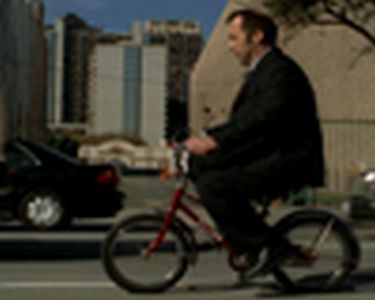 In this second commercial, a man is
about to set off home from work. While
most of his colleagues head for their
cars, he gets onto his bike and, in the
sequence that follows, has to negotiate
a number of dangerous scrapes in the
evening rush hour before finally arriving
home – in one piece, but totally
shattered.